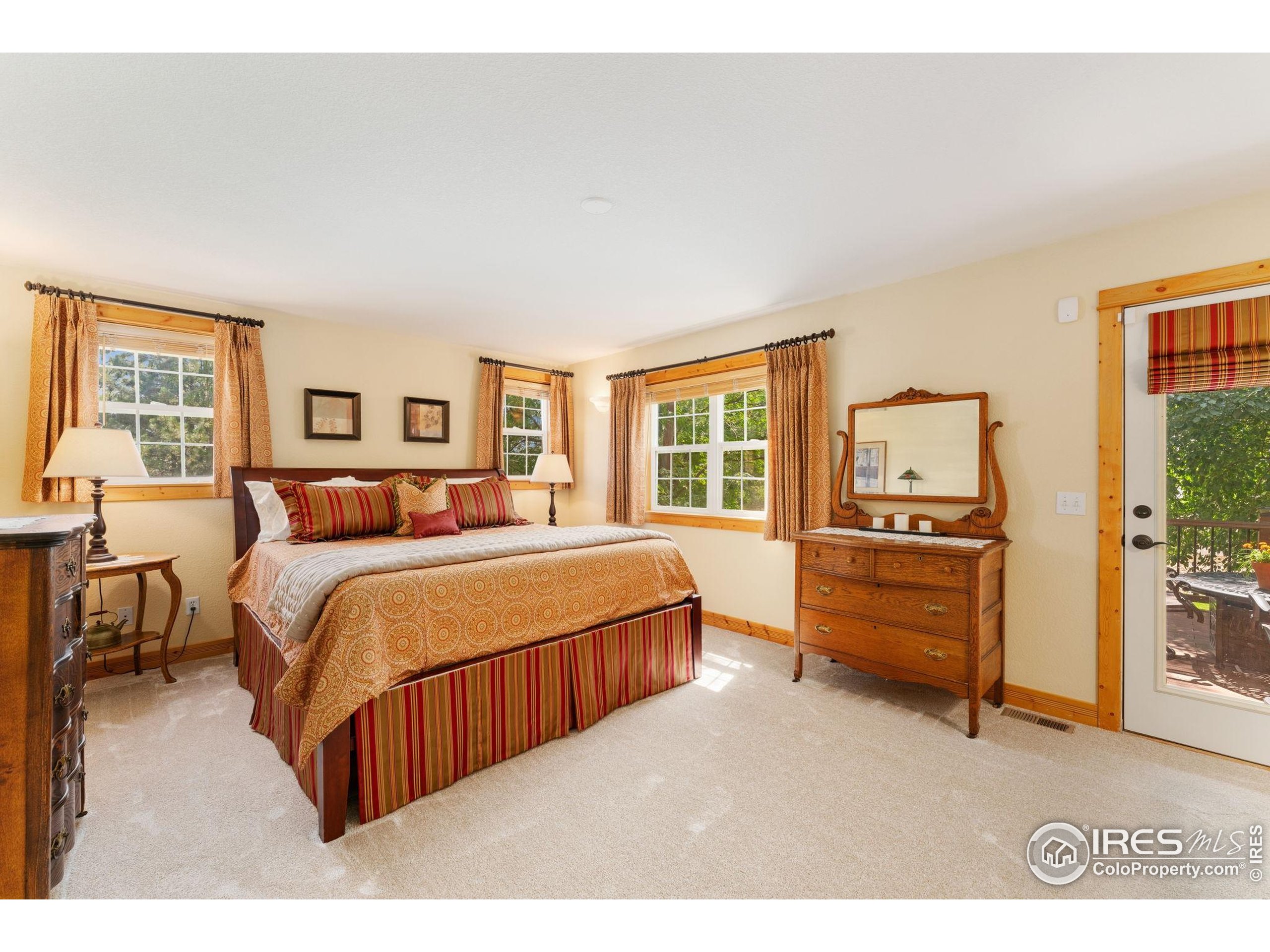 3302 Rinn Valley Drive Longmont, CO 80504 - Photo 13 of 45 a bedroom with a bed and a dresser with mirror