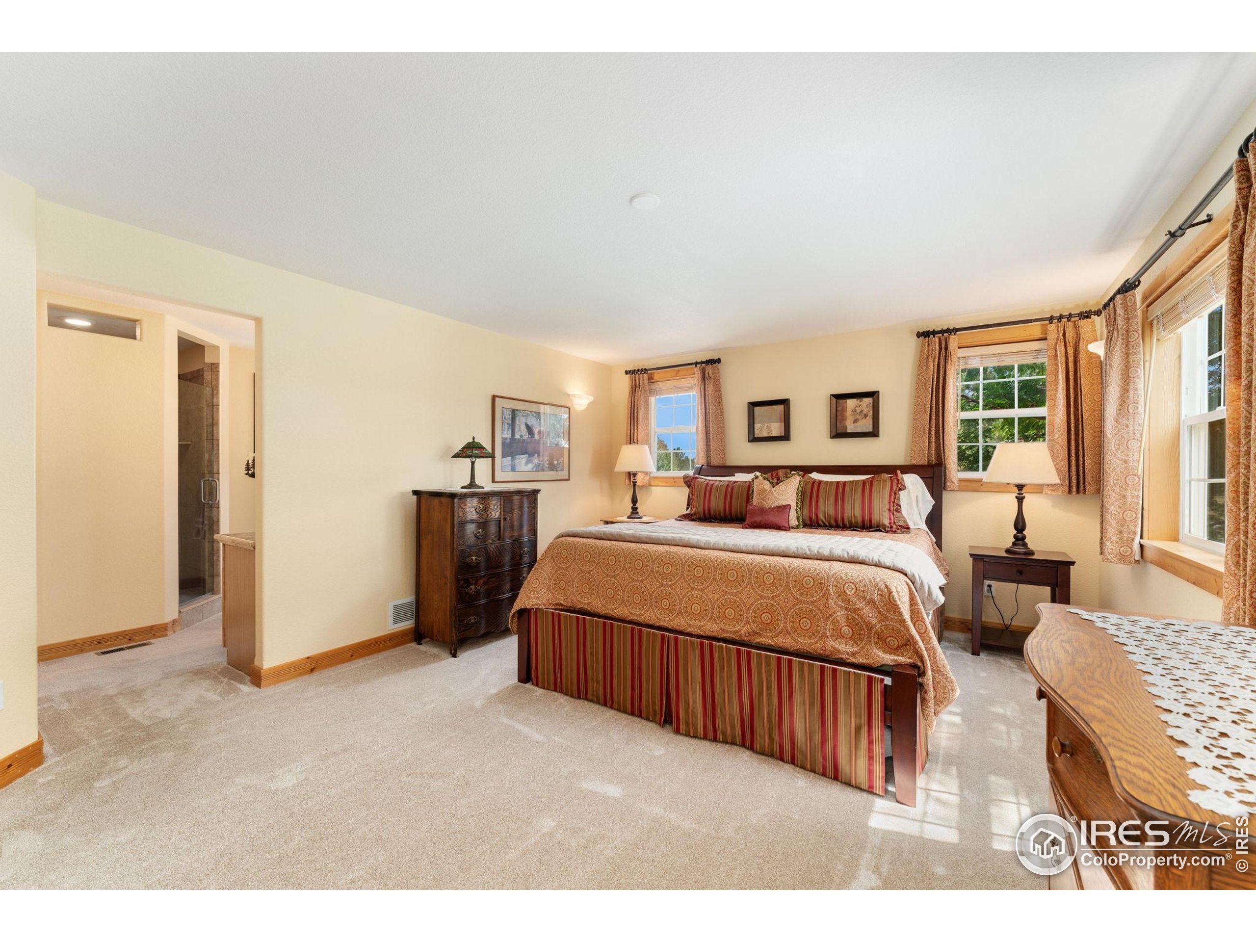 3302 Rinn Valley Drive Longmont, CO 80504 - Photo 14 of 45 a bedroom with a large bed and a large window