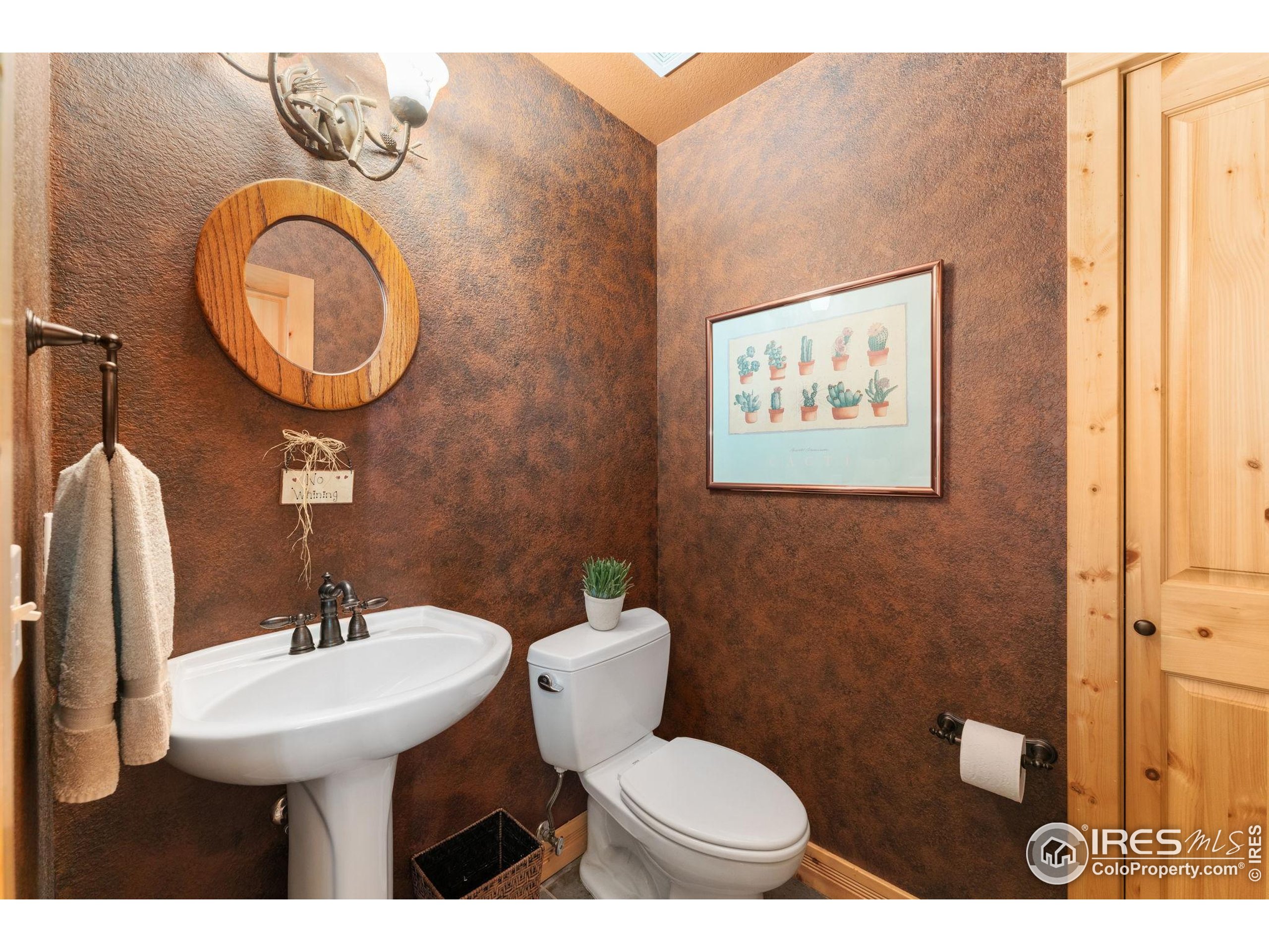 3302 Rinn Valley Drive Longmont, CO 80504 - Photo 16 of 45 a bathroom with a toilet a sink and a mirror