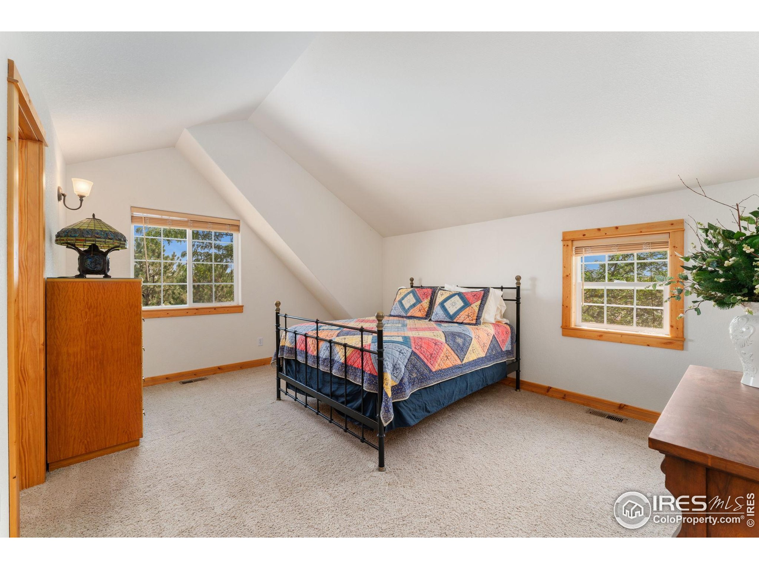 3302 Rinn Valley Drive Longmont, CO 80504 - Photo 24 of 45 a spacious bedroom with a bed and a window