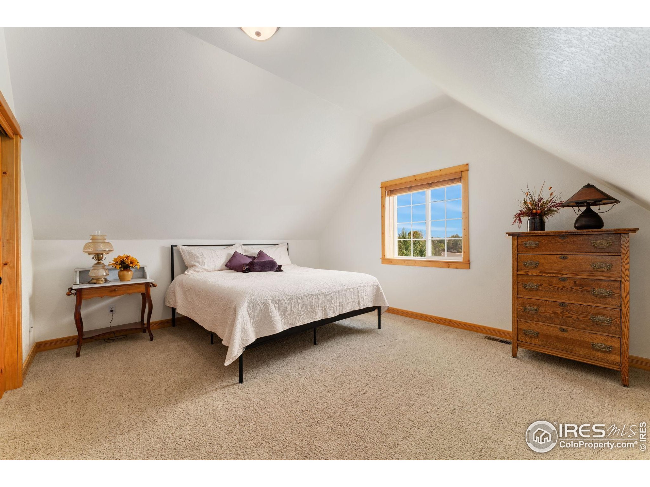 3302 Rinn Valley Drive Longmont, CO 80504 - Photo 26 of 45 a bedroom with a bed and a dresser