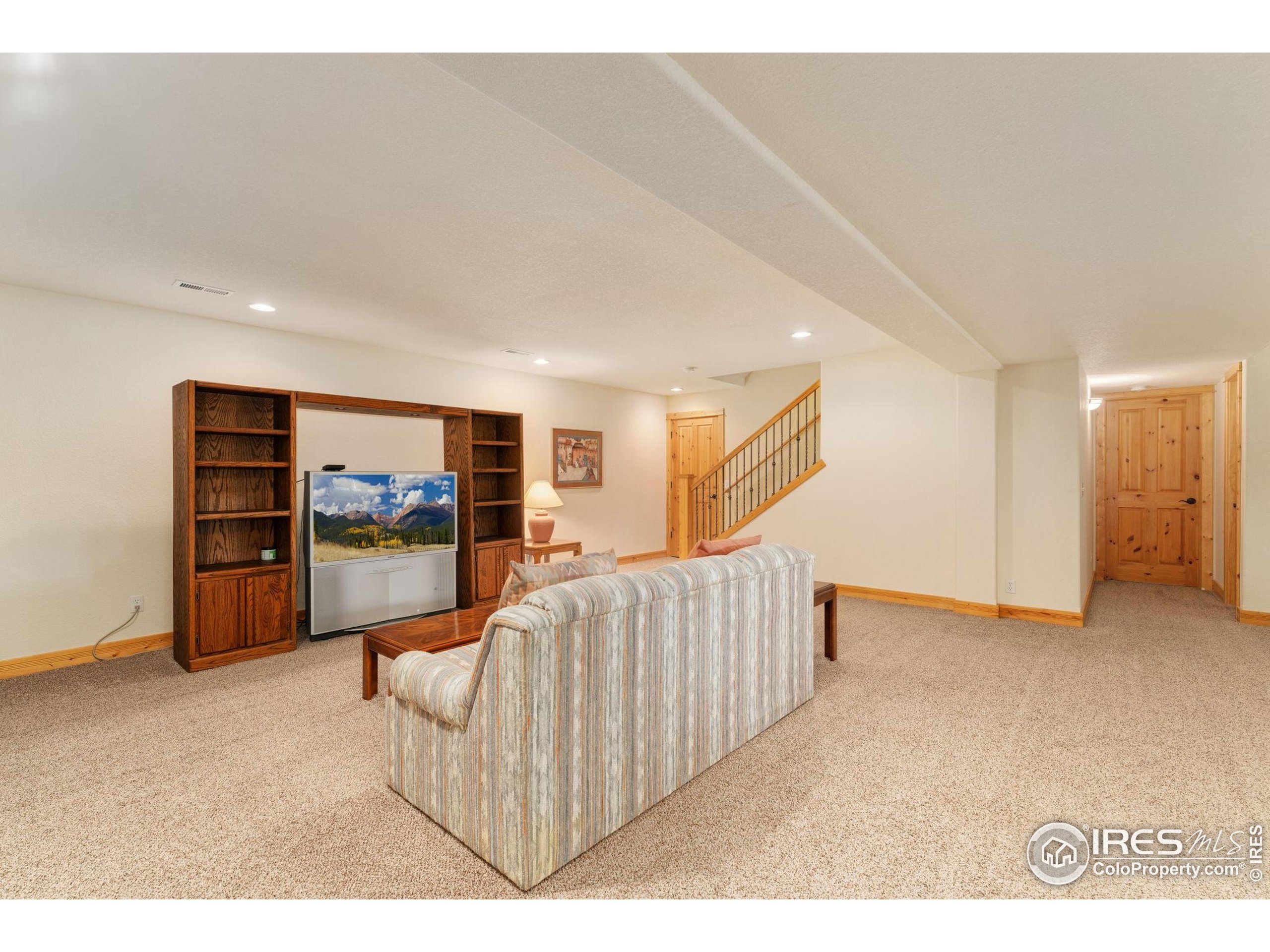 3302 Rinn Valley Drive Longmont, CO 80504 - Photo 29 of 45 a living room with furniture and a flat screen tv