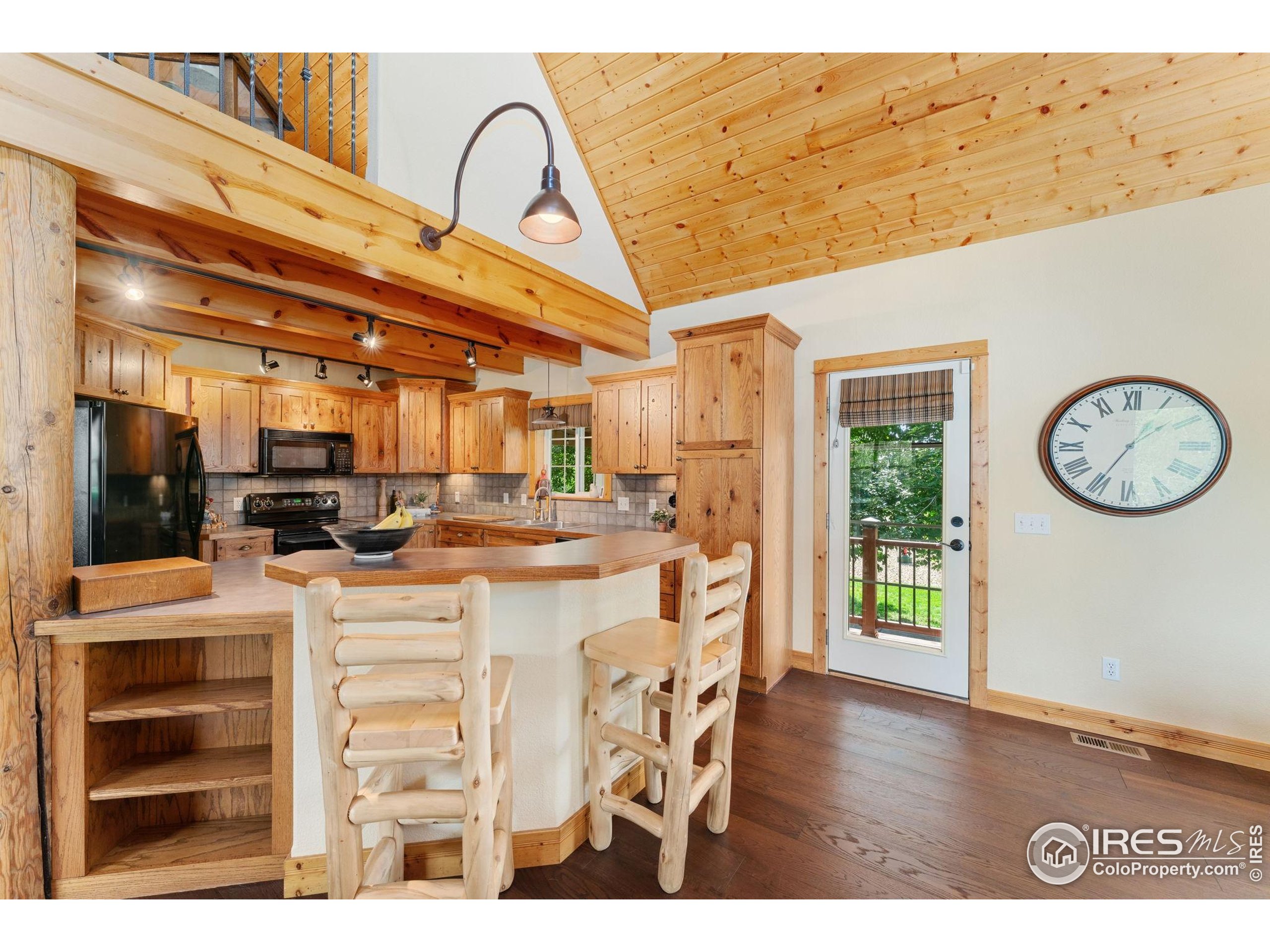 3302 Rinn Valley Drive Longmont, CO 80504 - Photo 7 of 45 a view of a kitchen with furniture and wooden floor