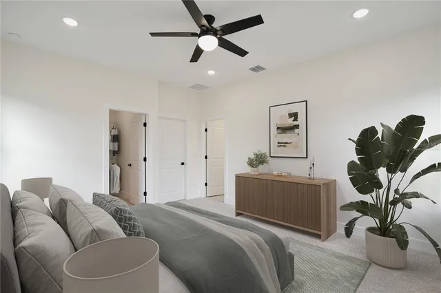 a living room with furniture potted plant and a ceiling fan