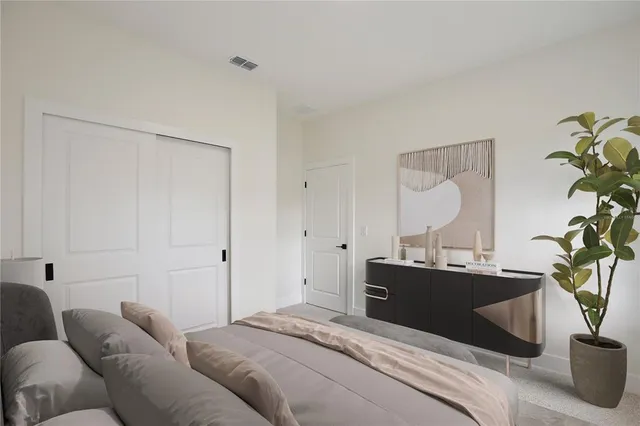 a bedroom with a bed and a potted plant