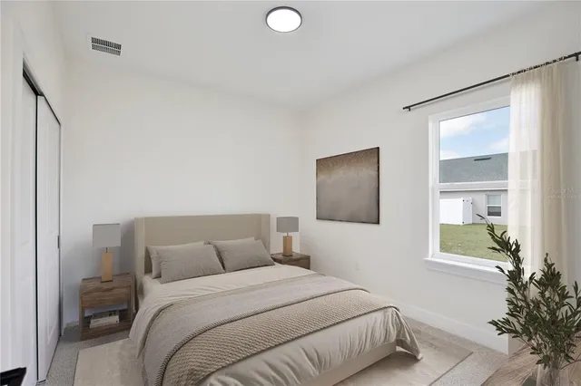 a bedroom with a bed and a potted plant