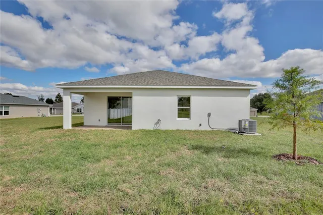 a view of a house with a yard and garage
