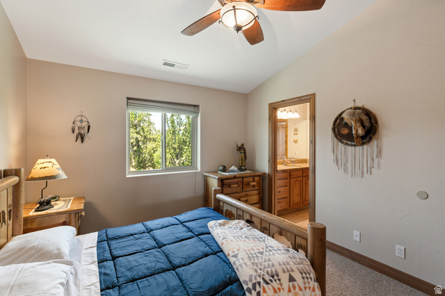 755 South Zion Ridge Drive Orderville, UT 84758 - Photo 60 of 84 Bedroom featuring lofted ceiling, carpet flooring, connected bathroom, and ceiling fan