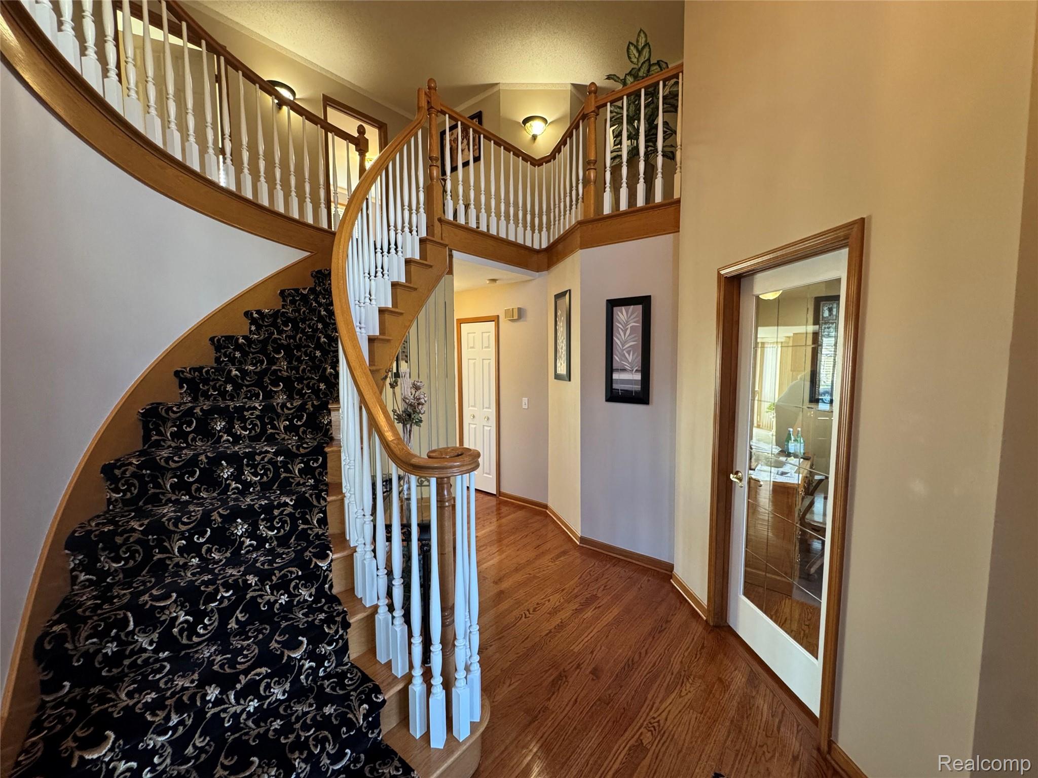 48583 Tilch Road Macomb, MI 48044 - Photo 8 of 53 Staircase featuring a high ceiling and wood finished floors