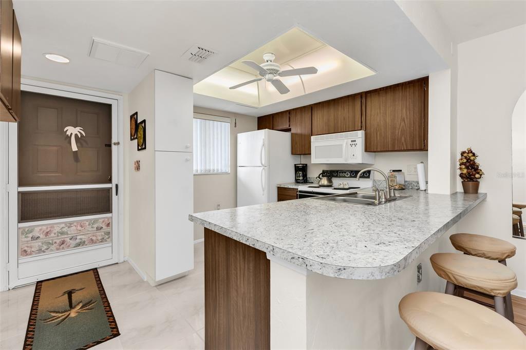 25225 Rampart Boulevard, Unit 1604 Punta Gorda, FL 33983 - Photo 9 of 41 a kitchen with stainless steel appliances granite countertop a sink refrigerator and cabinets