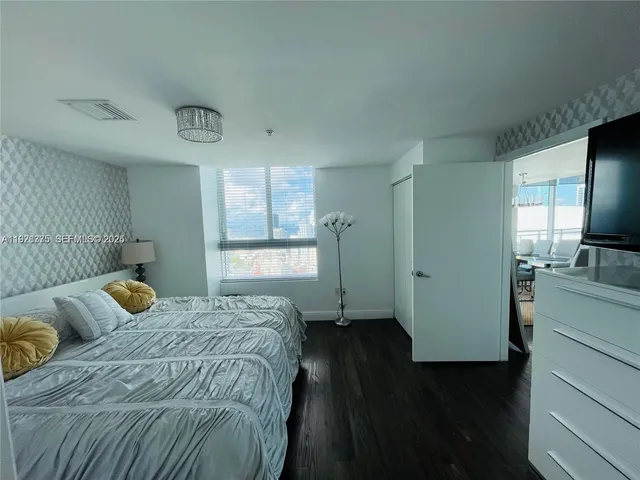 a bedroom with a bed and a television in it