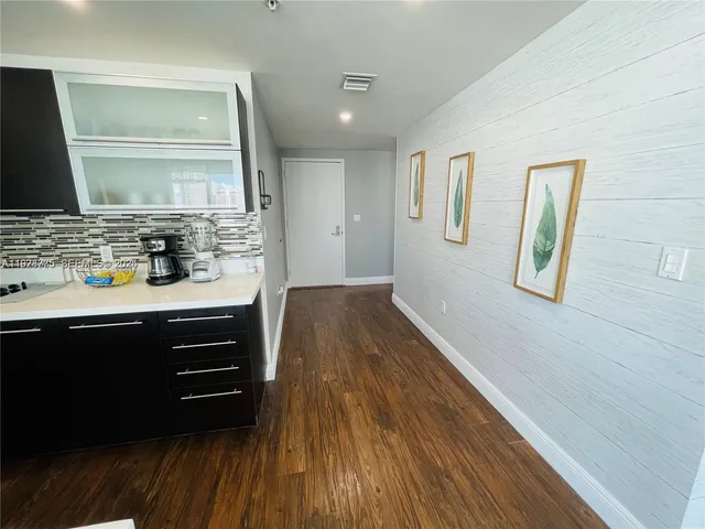 a room with a wooden floor and bathroom