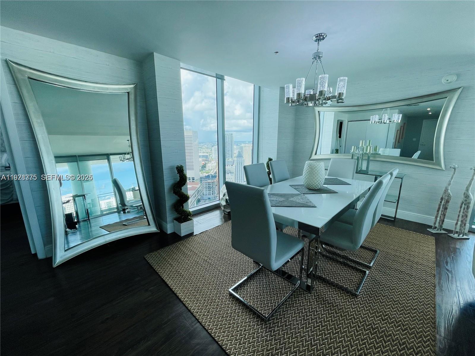 90 Southwest 3rd Street, Unit 4404 Miami, FL 33130 - Photo 8 of 28 a view of a dining room with furniture window and wooden floor