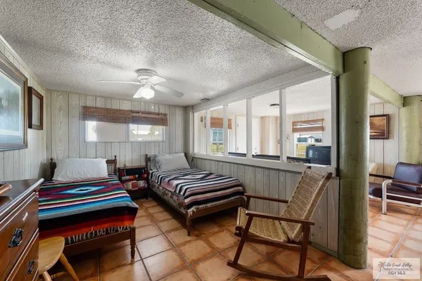 a living room with furniture a ceiling fan and a window
