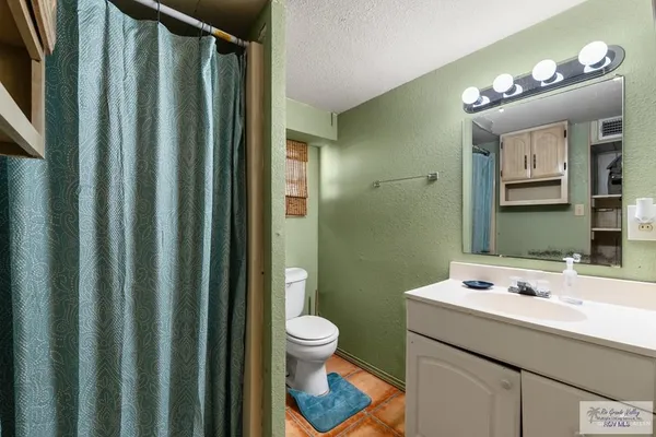 a bathroom with a sink a toilet and mirror