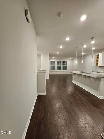 a view of a kitchen with a sink and wooden floor