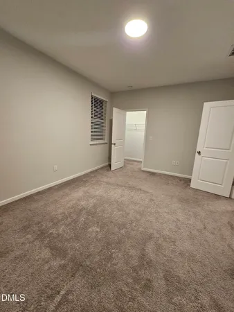 an empty room with an entrance to other room