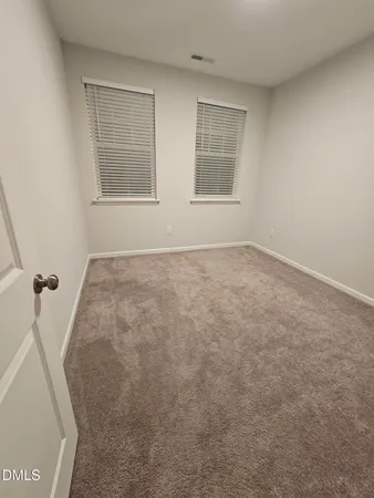 a view of an empty room with windows