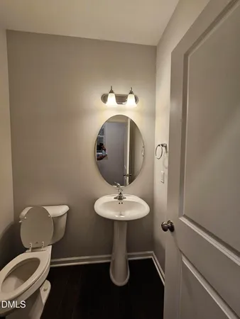 a bathroom with a toilet sink and a mirror