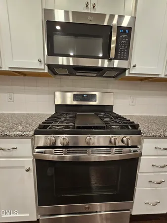 a stove top oven sitting inside of a kitchen