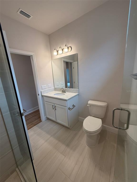 9654 Southwest 67th Lane Gainesville, FL 32608 - Photo 16 of 44 a bathroom with a toilet sink and mirror