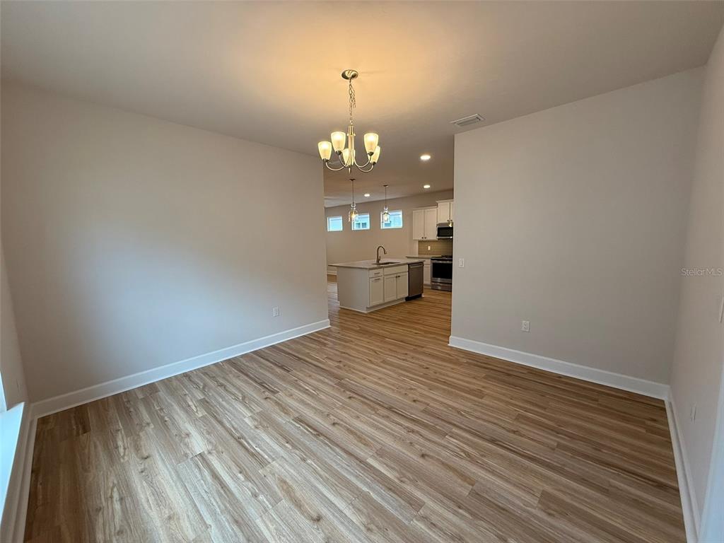 9654 Southwest 67th Lane Gainesville, FL 32608 - Photo 20 of 44 wooden floor in an empty room with a window
