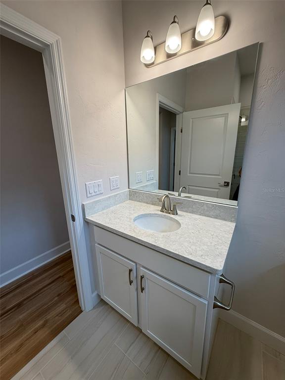 9654 Southwest 67th Lane Gainesville, FL 32608 - Photo 24 of 44 a bathroom with a sink a light fixture and a mirror