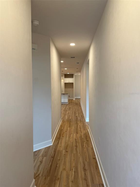9654 Southwest 67th Lane Gainesville, FL 32608 - Photo 3 of 44 a view of a hallway with wooden floor