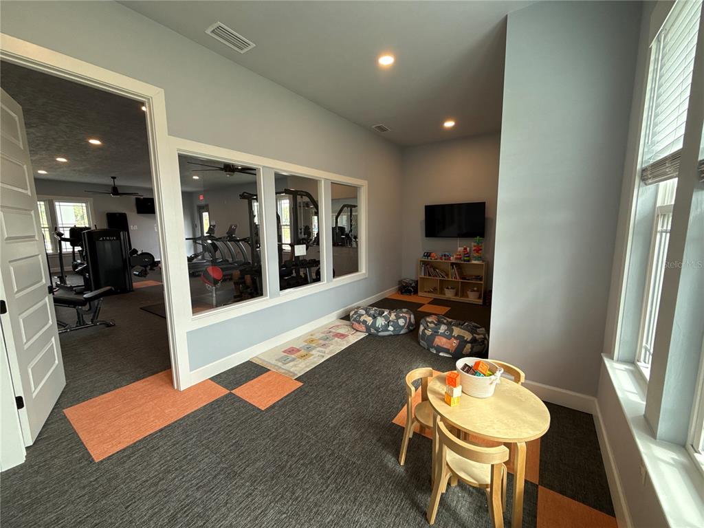 9654 Southwest 67th Lane Gainesville, FL 32608 - Photo 35 of 44 a living room with furniture and a flat screen tv