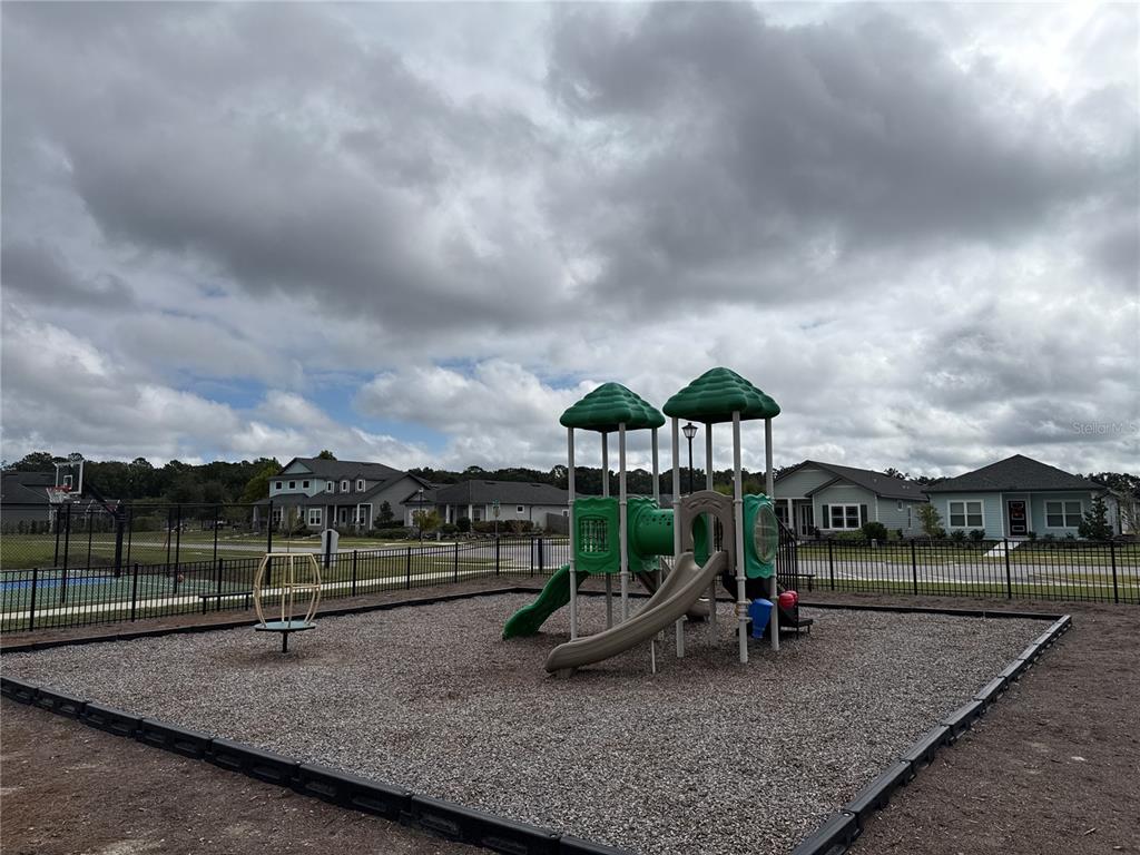 9654 Southwest 67th Lane Gainesville, FL 32608 - Photo 36 of 44 a view of a park with swings and slides