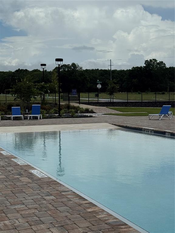 9654 Southwest 67th Lane Gainesville, FL 32608 - Photo 44 of 44 a view of swimming pool with outdoor seating and mountain in the back