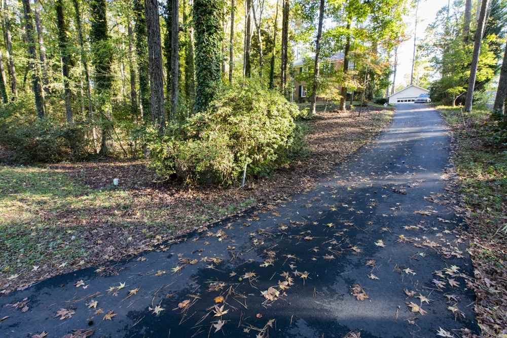 3417 Angus Road Durham, NC 27705 - Photo 2 of 21 An asphalt driveway with large parking pad provides plenty of space to park