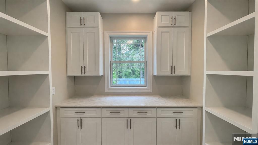 405 Valley Road River Edge, NJ 07661 - Photo 10 of 20 a kitchen with white cabinets and a window