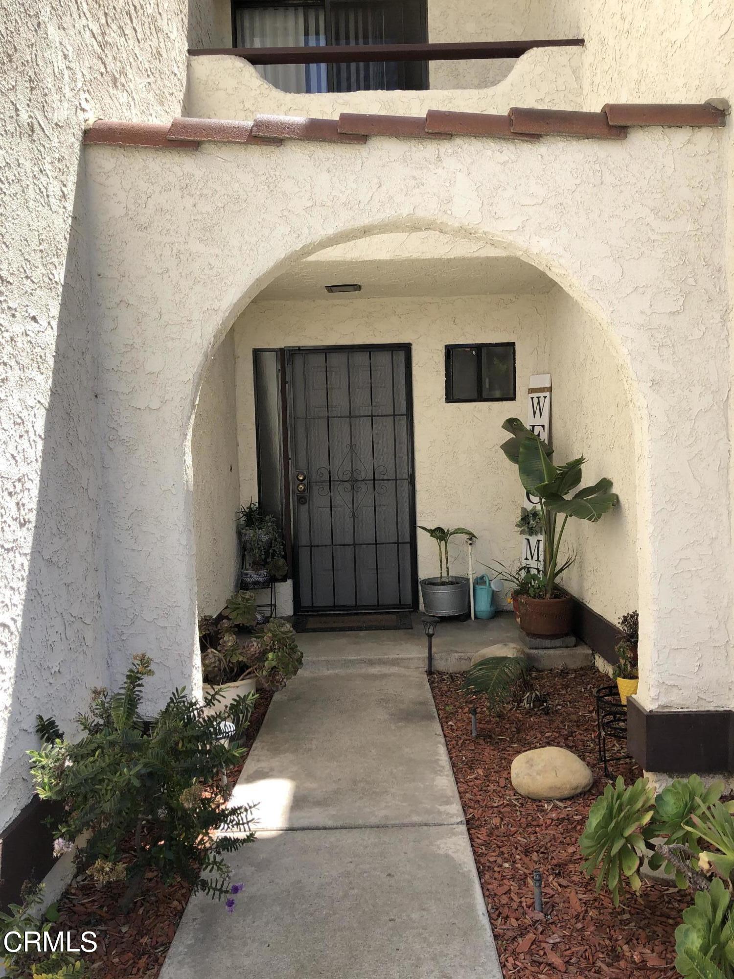 352 East Bard Road Oxnard, CA 93033 - Photo 2 of 26 a potted plant sitting in front of a door