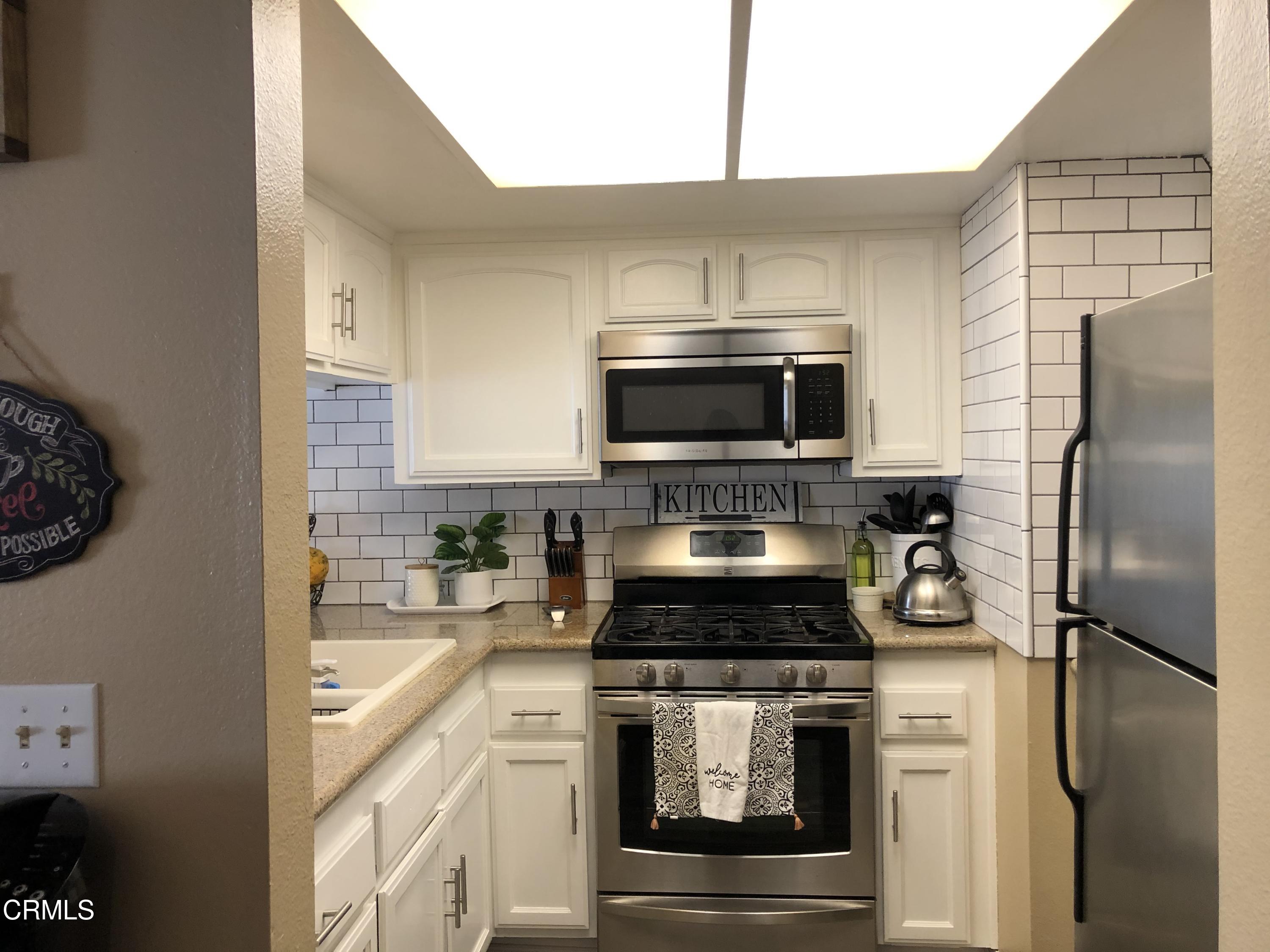 352 East Bard Road Oxnard, CA 93033 - Photo 11 of 26 a kitchen with a refrigerator stove and microwave