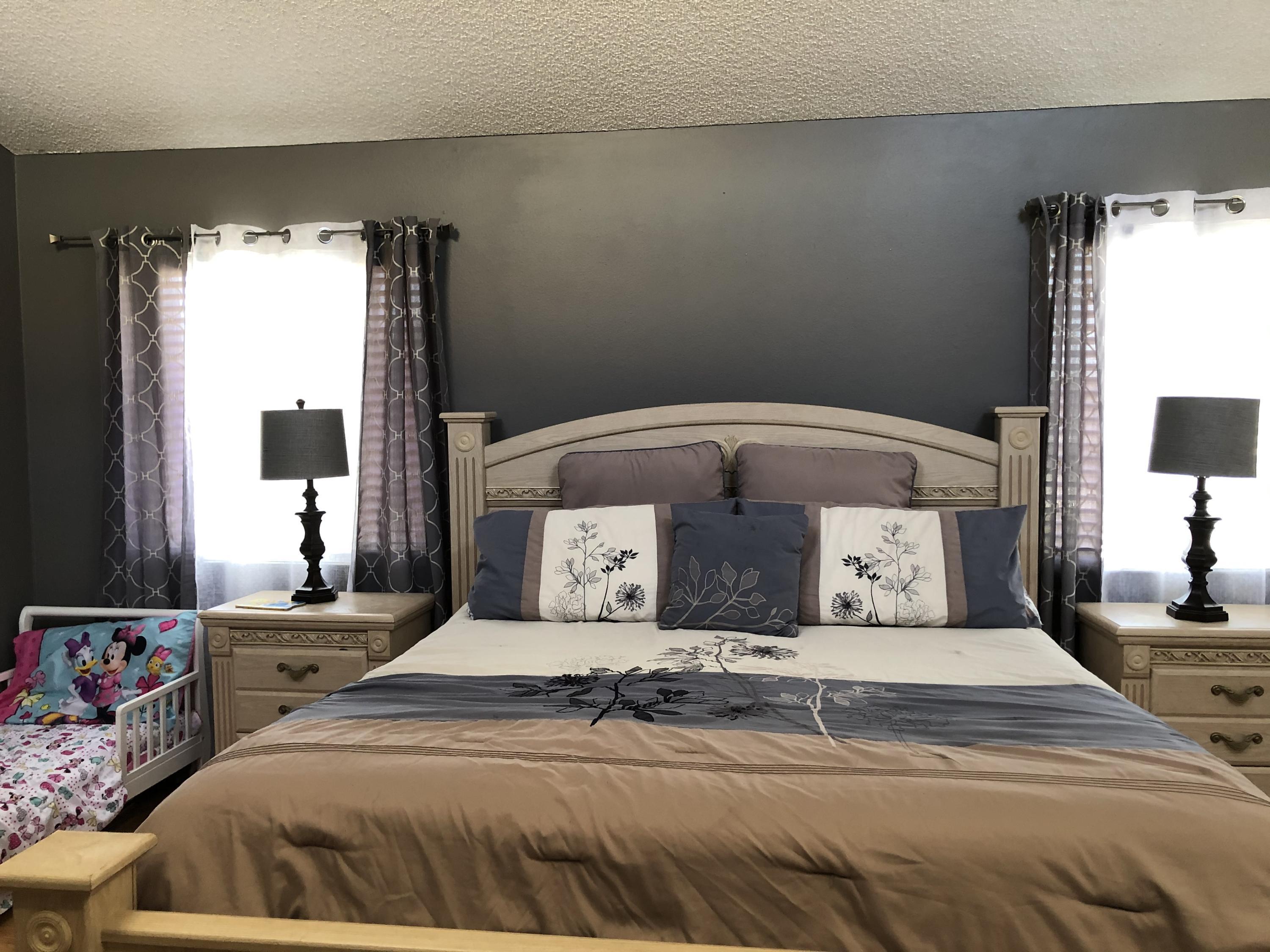 352 East Bard Road Oxnard, CA 93033 - Photo 18 of 26 a bedroom with a bed and a flat tv screen on dresser