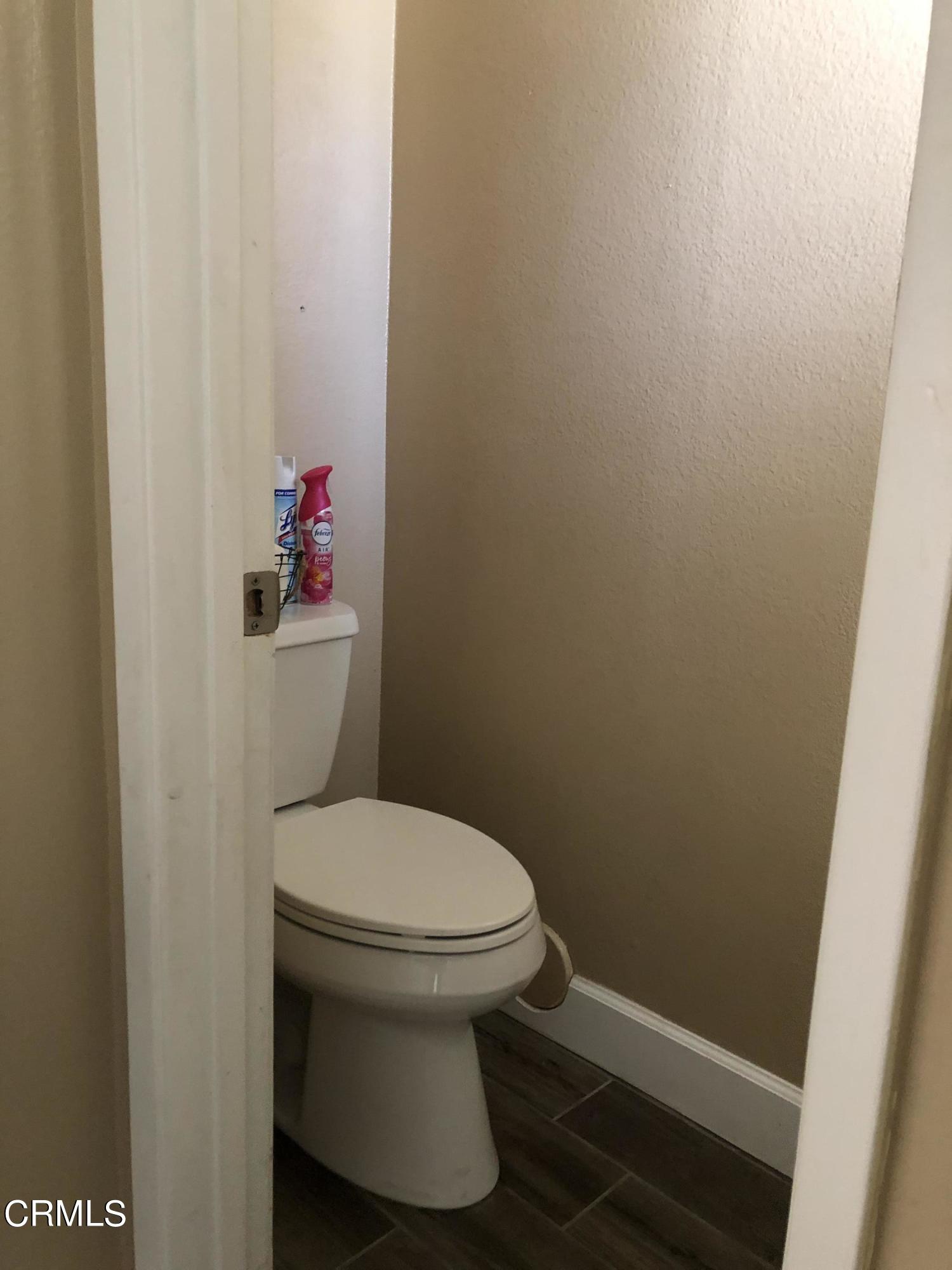352 East Bard Road Oxnard, CA 93033 - Photo 22 of 26 a white toilet sitting next to a white sink and vanity