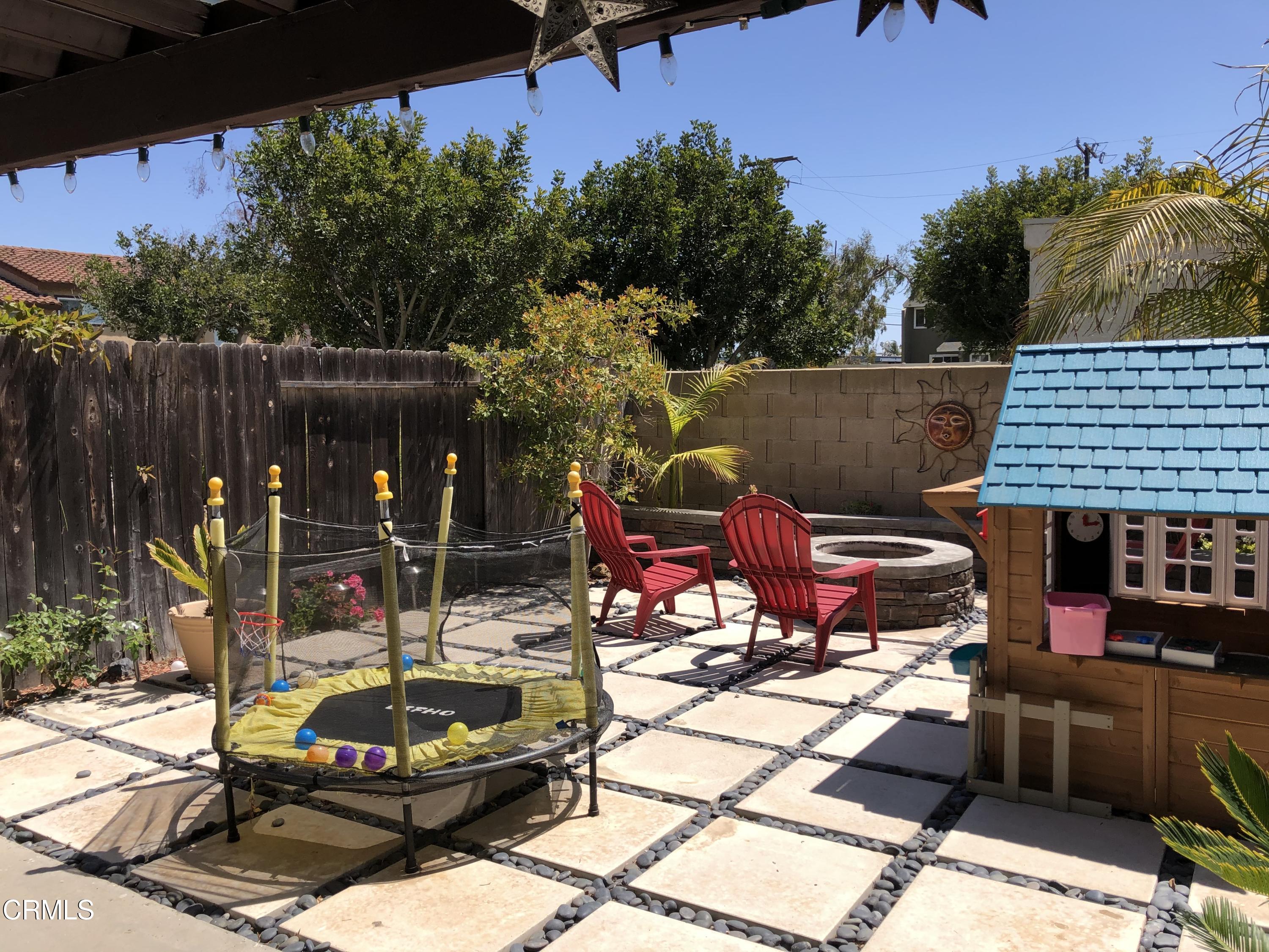 352 East Bard Road Oxnard, CA 93033 - Photo 24 of 26 a view of a backyard with table and chairs potted plants and tree