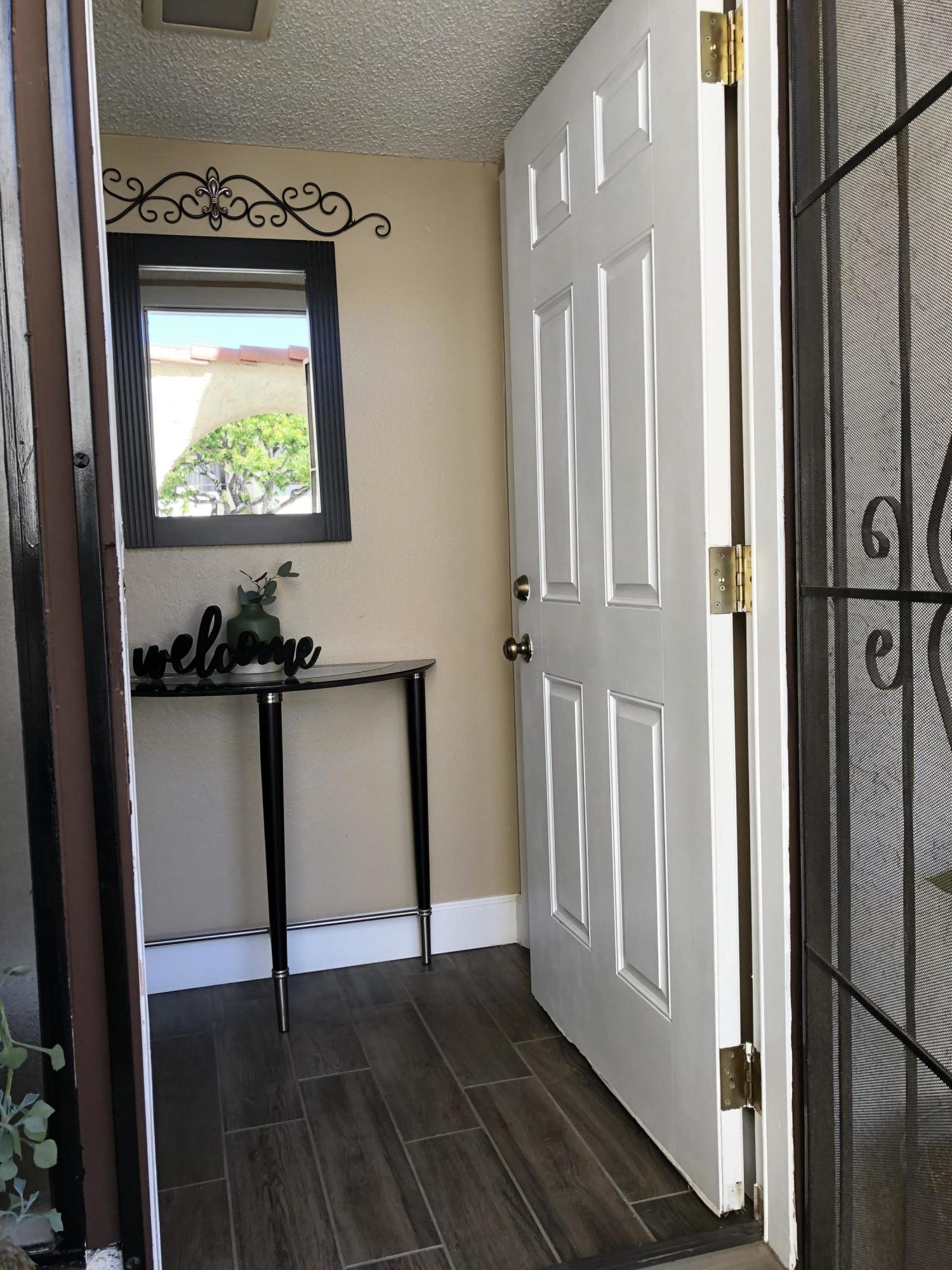 352 East Bard Road Oxnard, CA 93033 - Photo 4 of 26 a view of a hallway with wooden floor and stairs