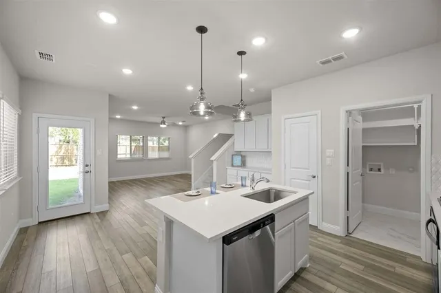 a kitchen with a sink and natural light