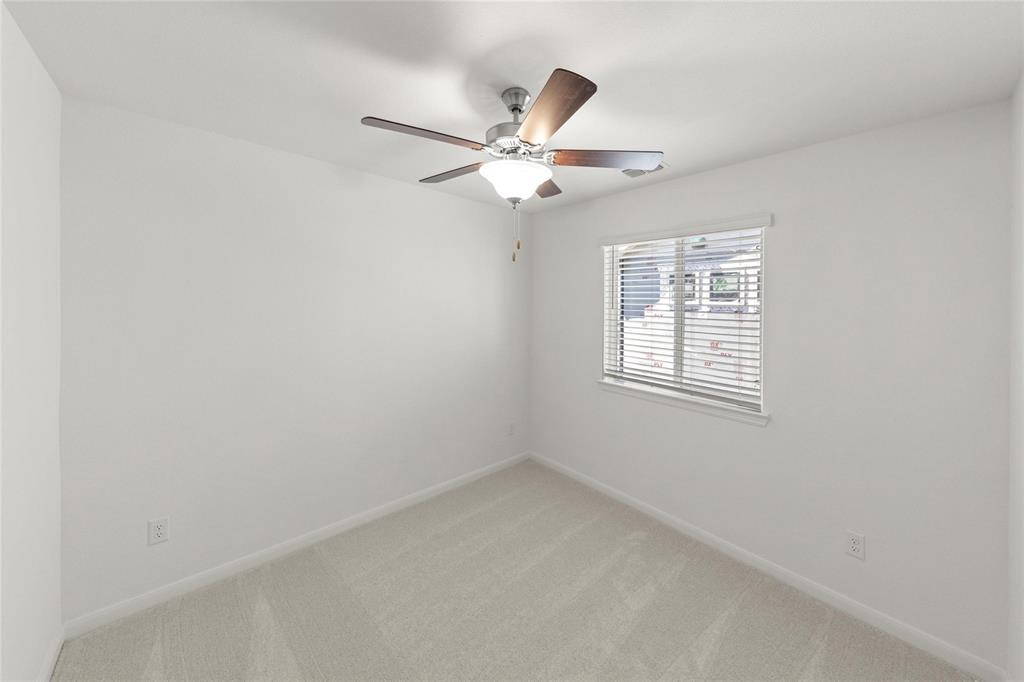 203 Griffith Drive Princeton, TX 75407 - Photo 13 of 15 an empty room with windows and fan