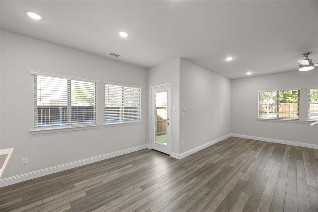 203 Griffith Drive Princeton, TX 75407 - Photo 3 of 15 an empty room with wooden floor and windows