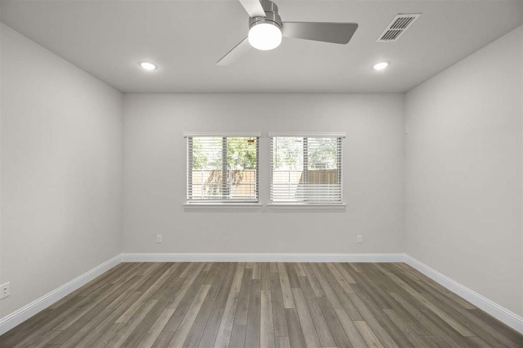 203 Griffith Drive Princeton, TX 75407 - Photo 4 of 15 an empty room with wooden floor and windows