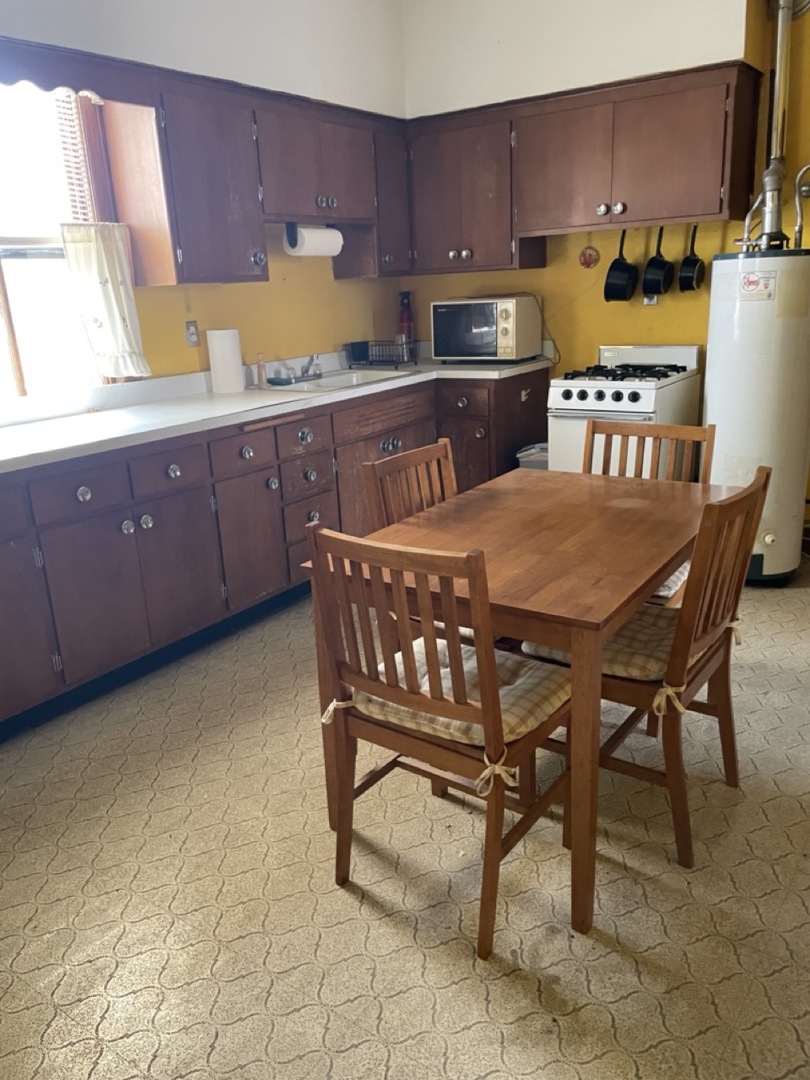 4555 South Francisco Avenue Chicago, IL 60632 - Photo 24 of 40 a kitchen with a chair and wooden cabinets