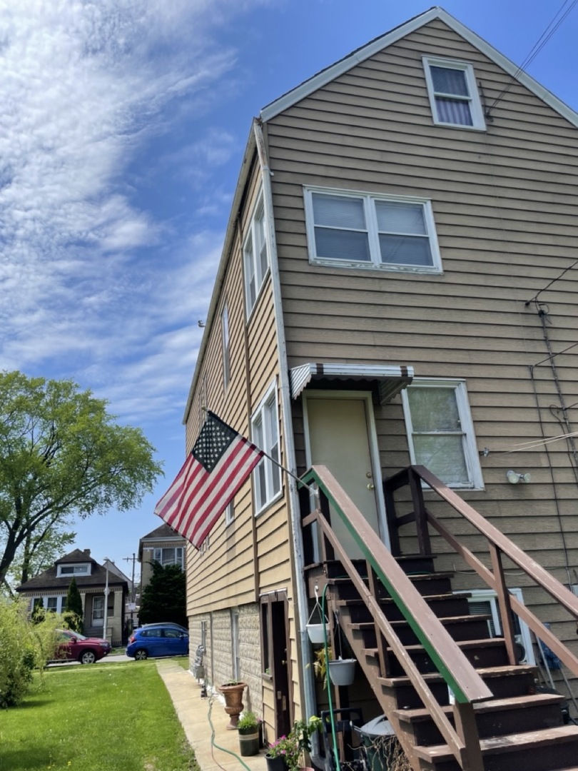 4555 South Francisco Avenue Chicago, IL 60632 - Photo 6 of 40 a front view of a house with a garden