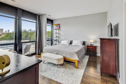 a bedroom with a bed and large window