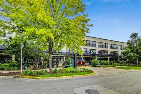 a front view of a house with a yard table and chairs