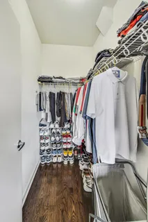 a view of walk in closet with clothes and shoes