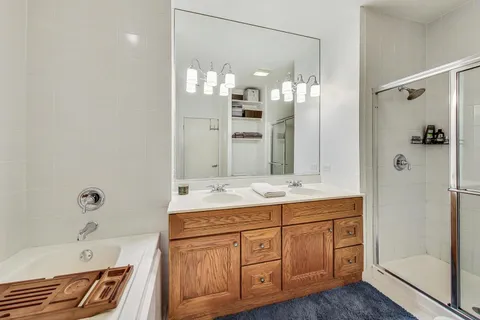 a bathroom with a granite countertop sink mirror and a shower
