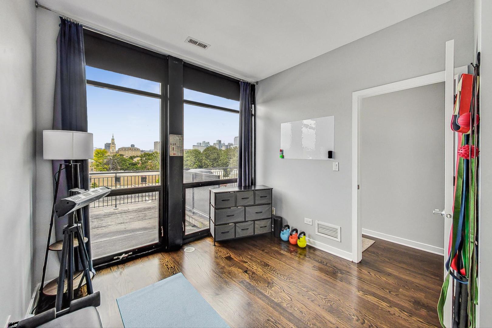 1111 West 14th Place, Unit 328 Chicago, IL 60608 - Photo 39 of 49 a living room with furniture and a window